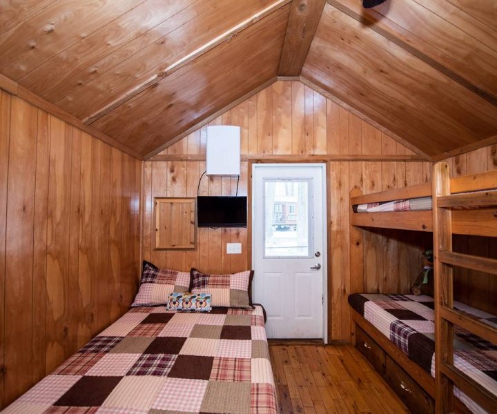 Boo Boo One Room Cabin interior, with twin bunk beds and full-size bed