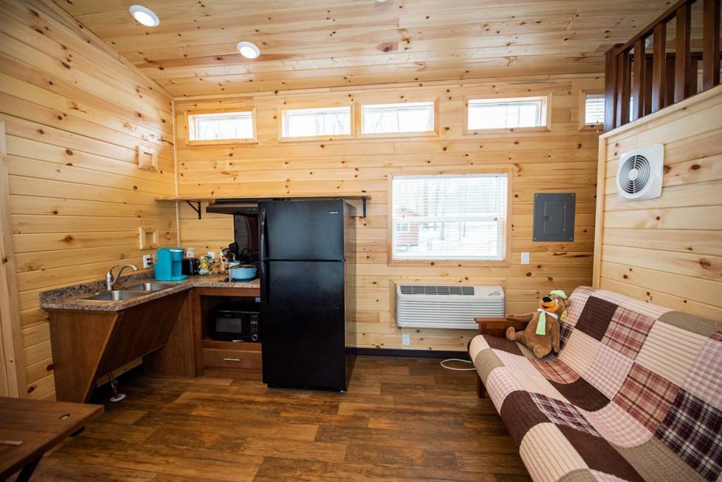 Cindy Bear cabin wheelchair access cabin interior with full-size futon, refrigerator, stove, microwave, and sink