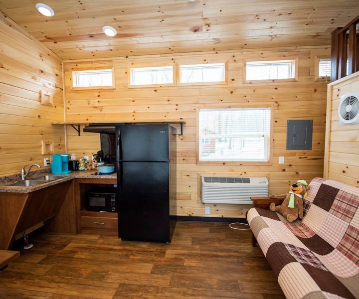 Cindy Bear cabin wheelchair access cabin interior with full-size futon, refrigerator, stove, microwave, and sink