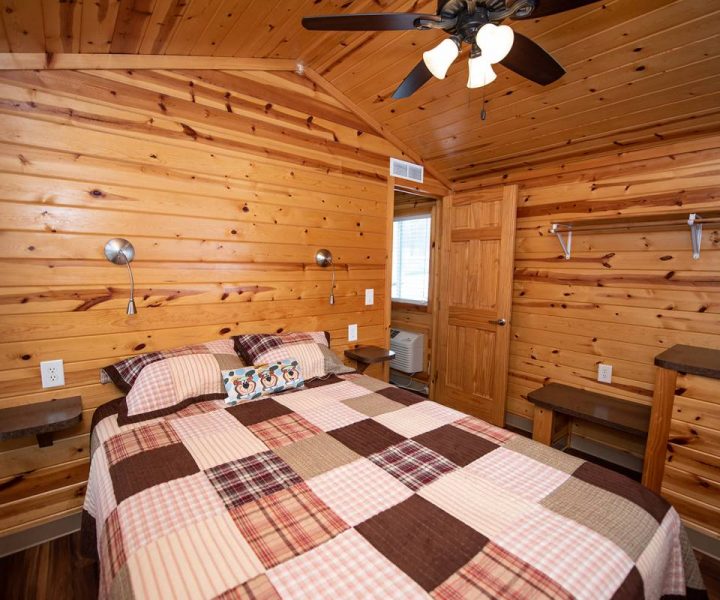 Cindy Bear cabin interior, master bedroom with queen-size bed and ceiling fan