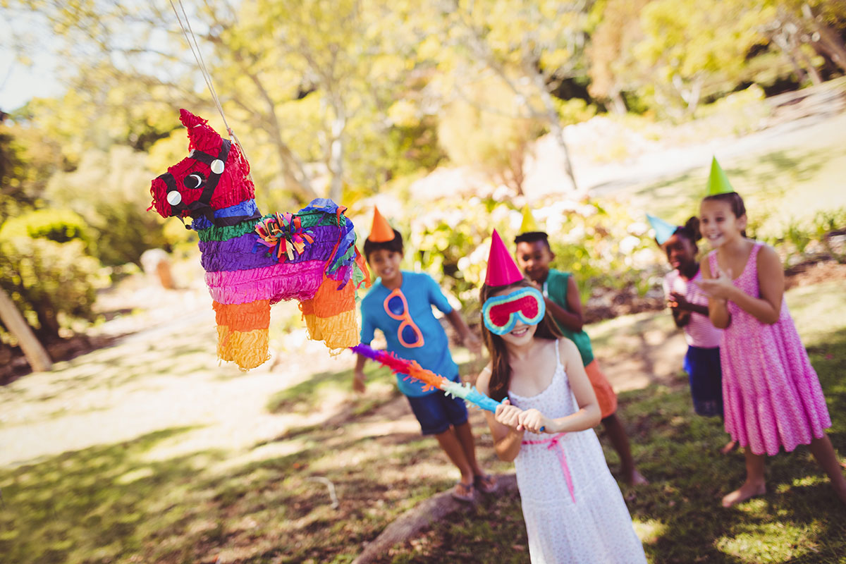 Children at a party with piñata