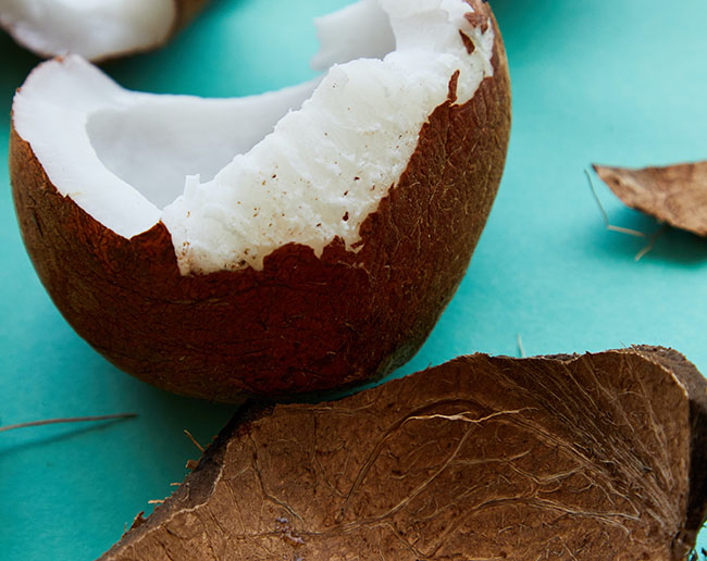 Broken coconut on table