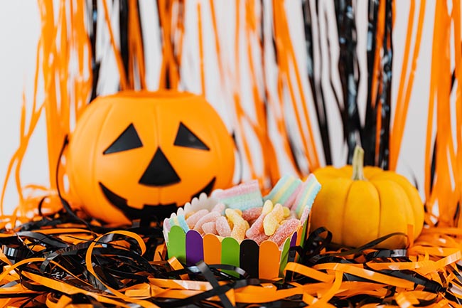 Candy basket, pumpkin, candy, and plastic streamers