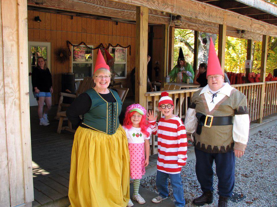 Costumed campers dressed as gnomes, with children dressed as strawberry shortcake and waldo