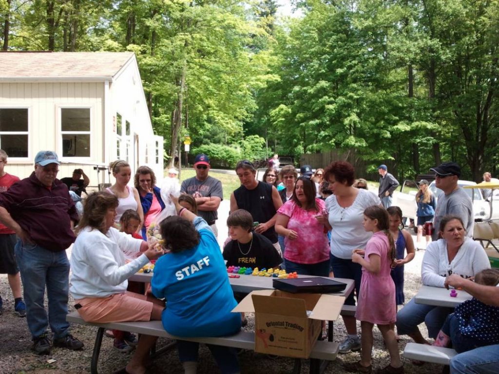 Many campers participating in a group activity involving multicolored rubber ducks