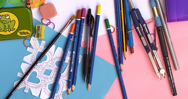 Construction paper and various pencils and school supplies